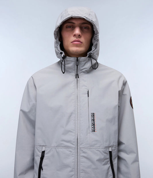 Napapijri Tundra Jacket in grey, lightweight outdoor jacket with hood, visible zippers, and durable fabric for outdoor wear.
