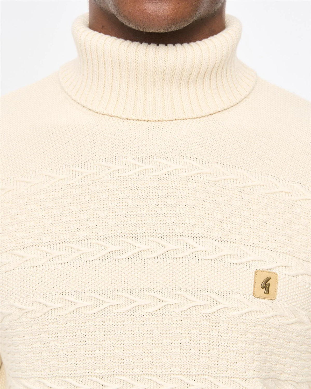 Cream Gabicci Vintage Emilio Roll Neck Knit Jumper displayed on a mannequin, highlighting its classic design and soft fabric.