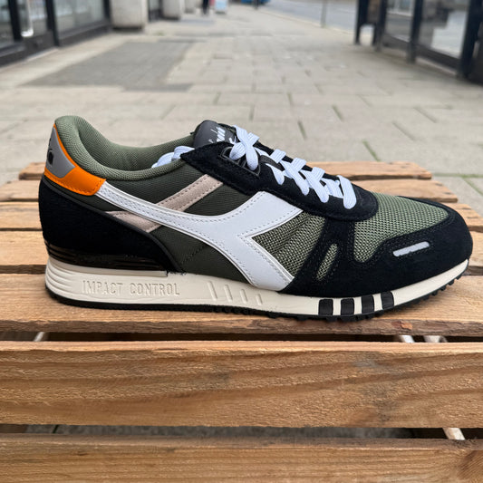 Diadora Titan Trainer shoes in Kombu Green, black, and white featuring a sporty design and supportive athletic sole.
