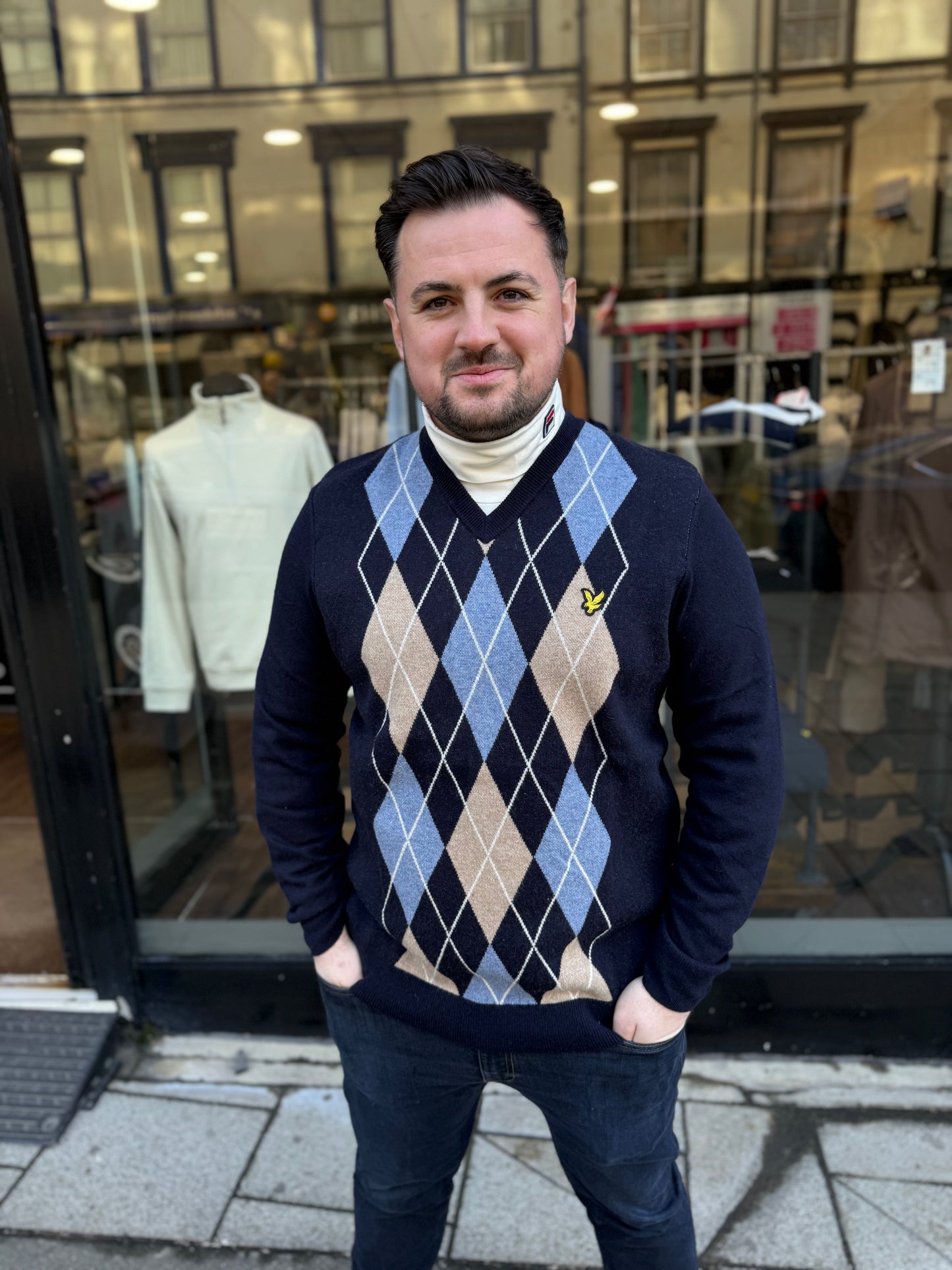 Lyle & Scott Lambswool blend argyle V-neck jumper in dark navy and cornflower blue marl, knitwear with argyle pattern details.