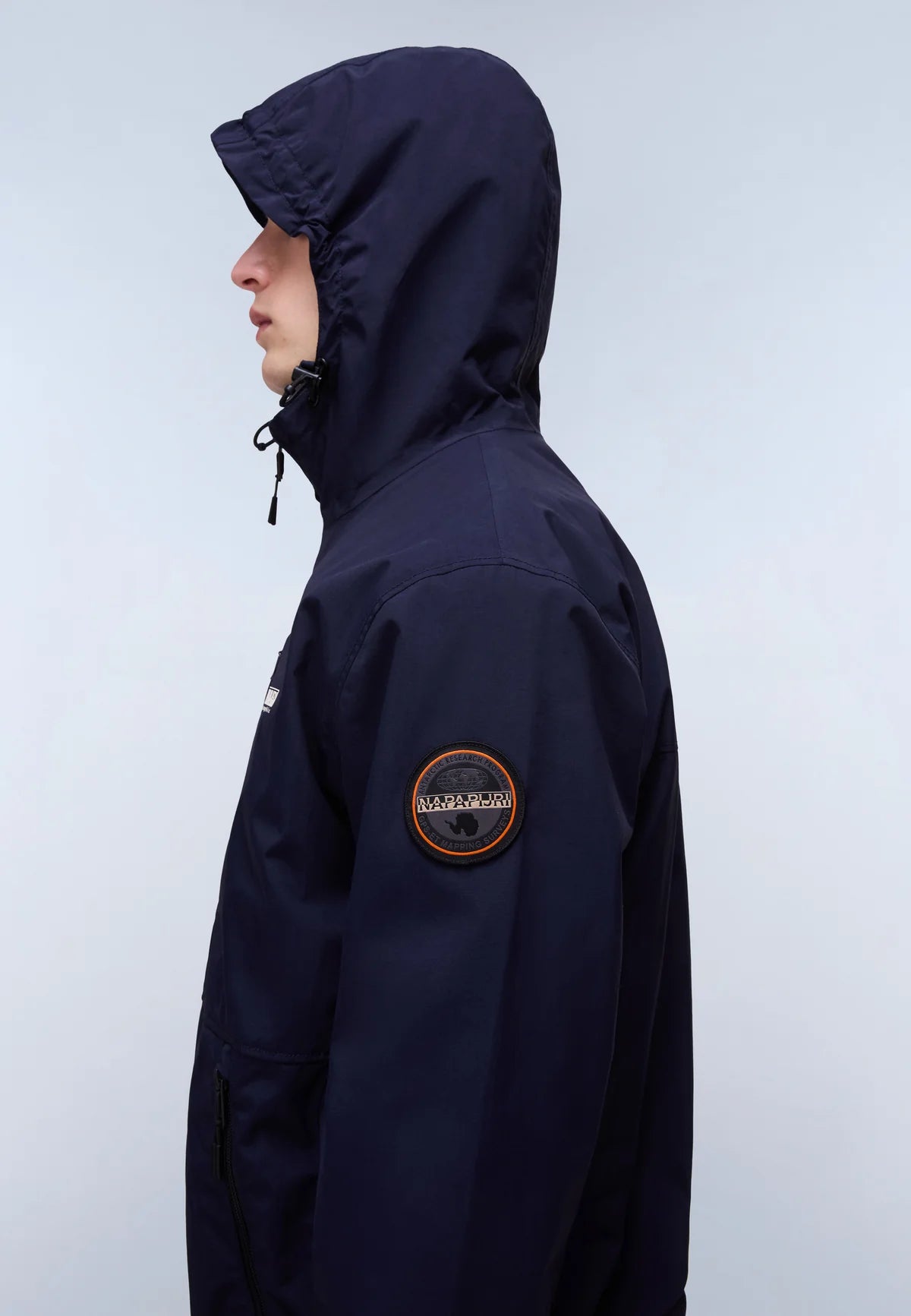 Navy Napapijri Tundra Jacket with hood and front zipper, shown on a hanger, featuring insulated design and durable outdoor fabric.