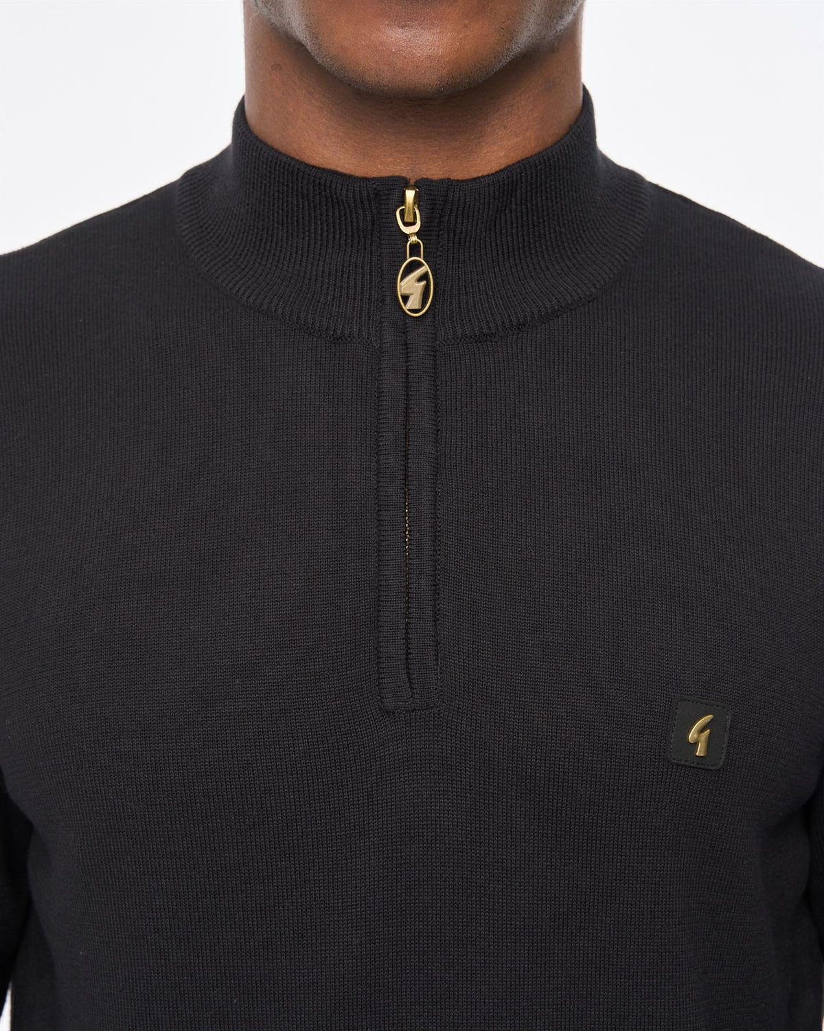 Black Gabicci Vintage Naxton quarter zip jumper, close-up of the stylish men's knit with a half-zip collar and textured fabric.