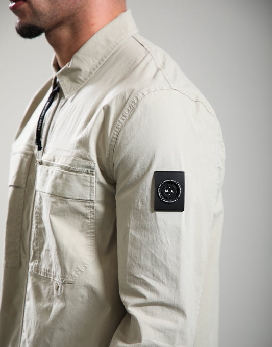 Marshall Artist Vanguard Overshirt in stone color, casual jacket with button closures and chest pockets, suitable for layered styling.