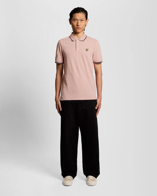 Men's Lyle & Scott pink and navy tipped polo shirt, featuring a classic collar and short sleeves, displayed on a plain background.