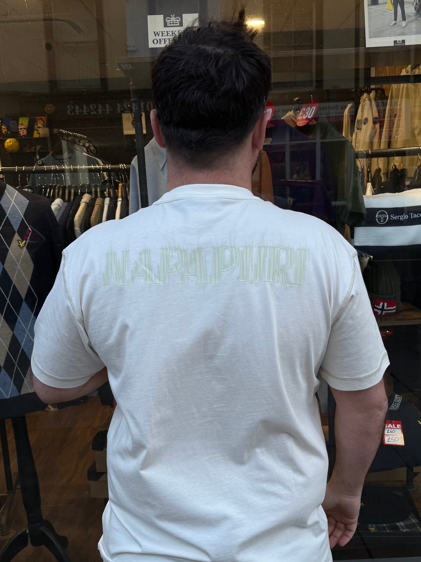 White Napapijri S-Umbra T-Shirt with subtle logo and relaxed fit, displayed on a hanger against a plain background.
