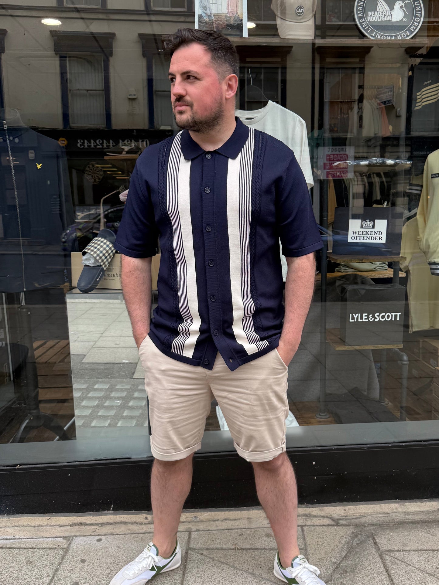 Arthur & Russell navy knitted stripe button-through polo shirt, showcasing a classic knitwear design with a collar and button placket.