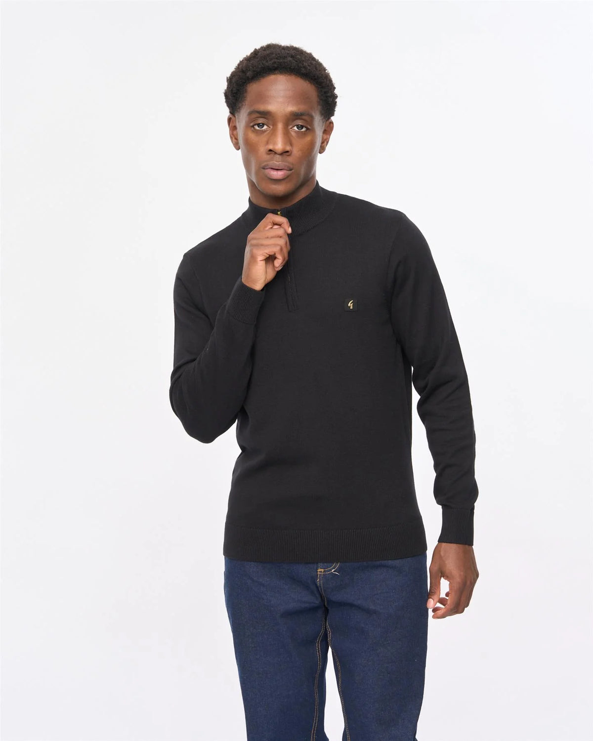 Black Gabicci Vintage Naxton quarter zip jumper featuring a high collar and ribbed cuffs, styled on a mannequin.