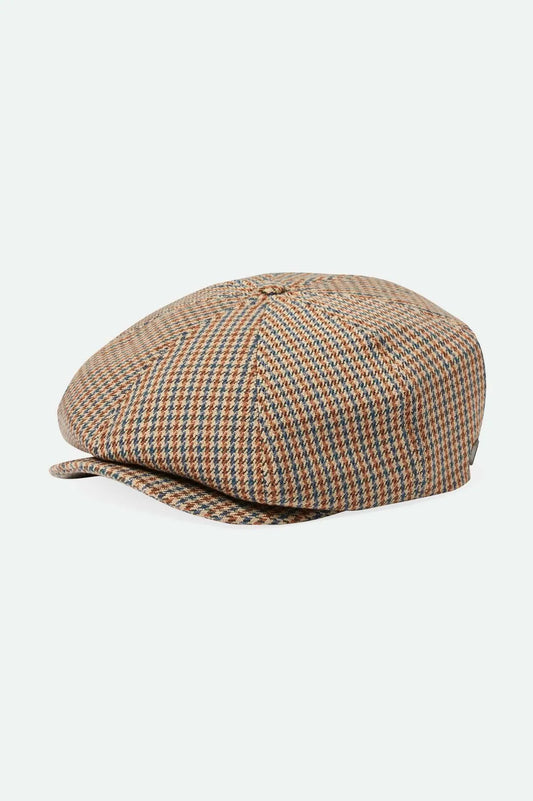 The Brood Snap Cap is one of our flagship silhouettes featuring a short front brim and custom liner. Refined with signature Brixton fabrics and a metal crest pin, you can bring storied style to everyday with this statement maker.