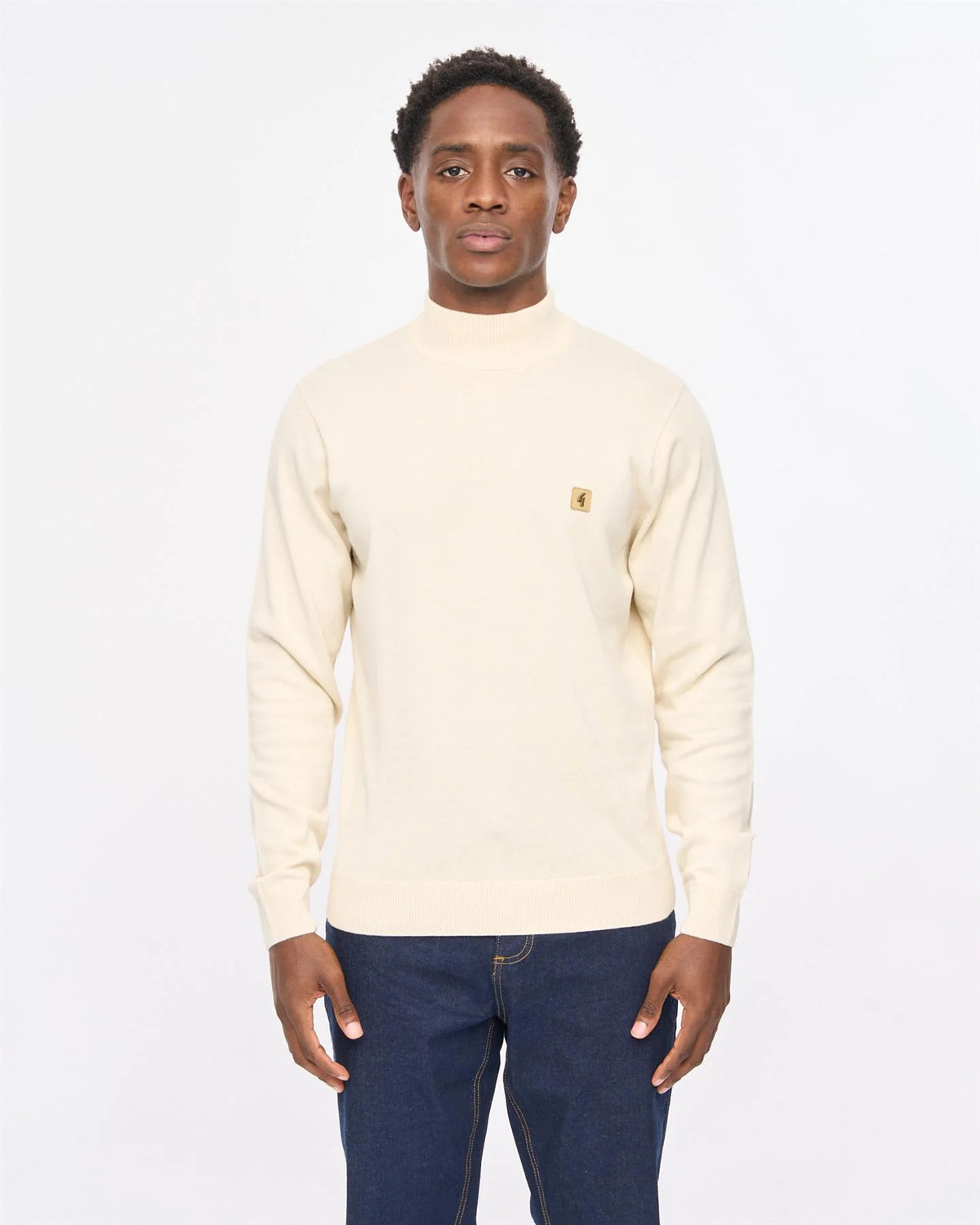 Cream-colored Gabicci Vintage Duke turtle neck knitwear, close-up of soft, textured fabric and classic style.