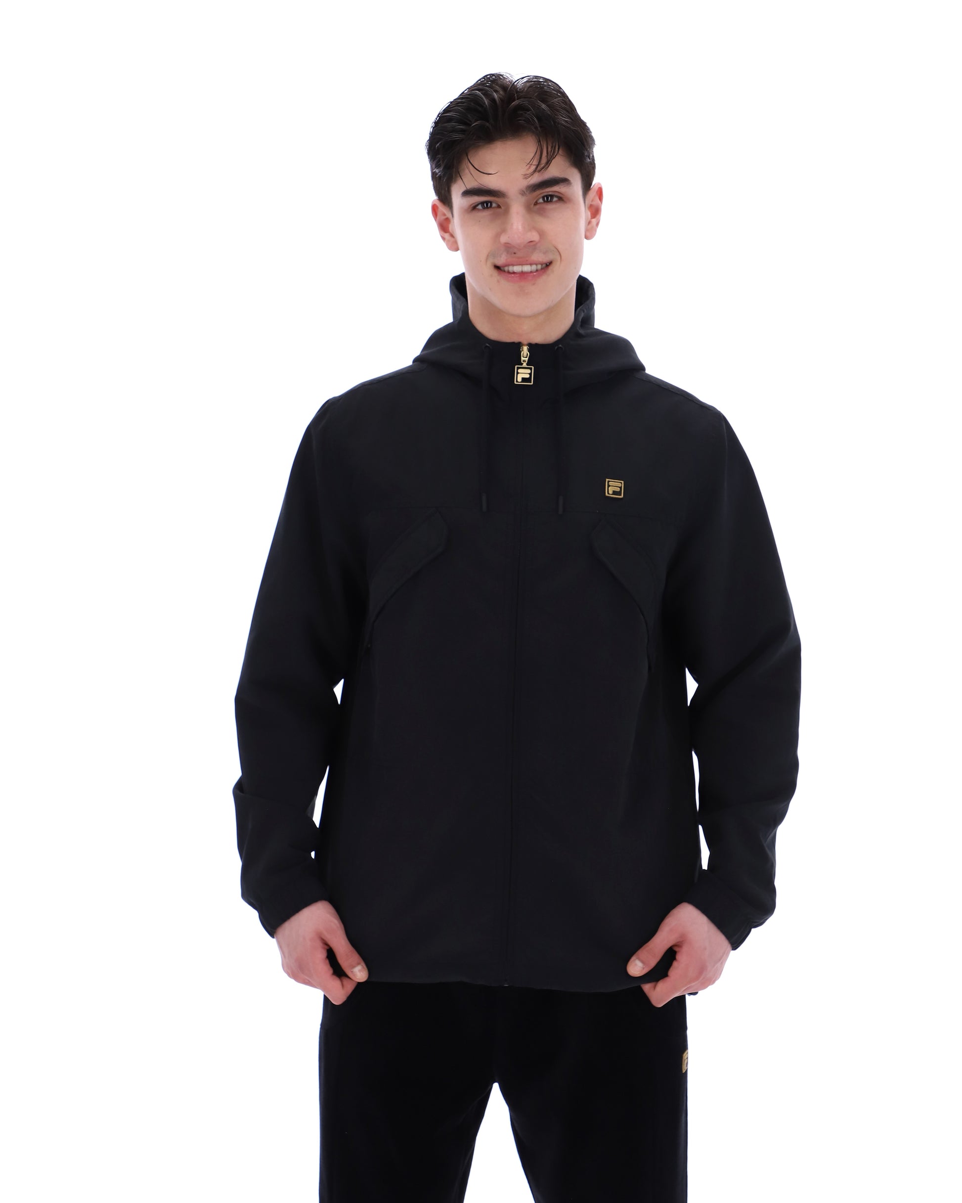 Black Fila lightweight jacket hanging on a hanger, showcasing its sleek design and comfortable fit.