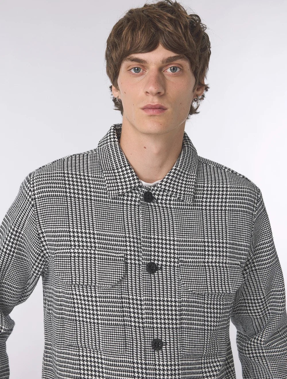 Black Pretty Green Alderley Prince of Wales jacket displayed on a hanger, showcasing classic tailored design and structured fit.