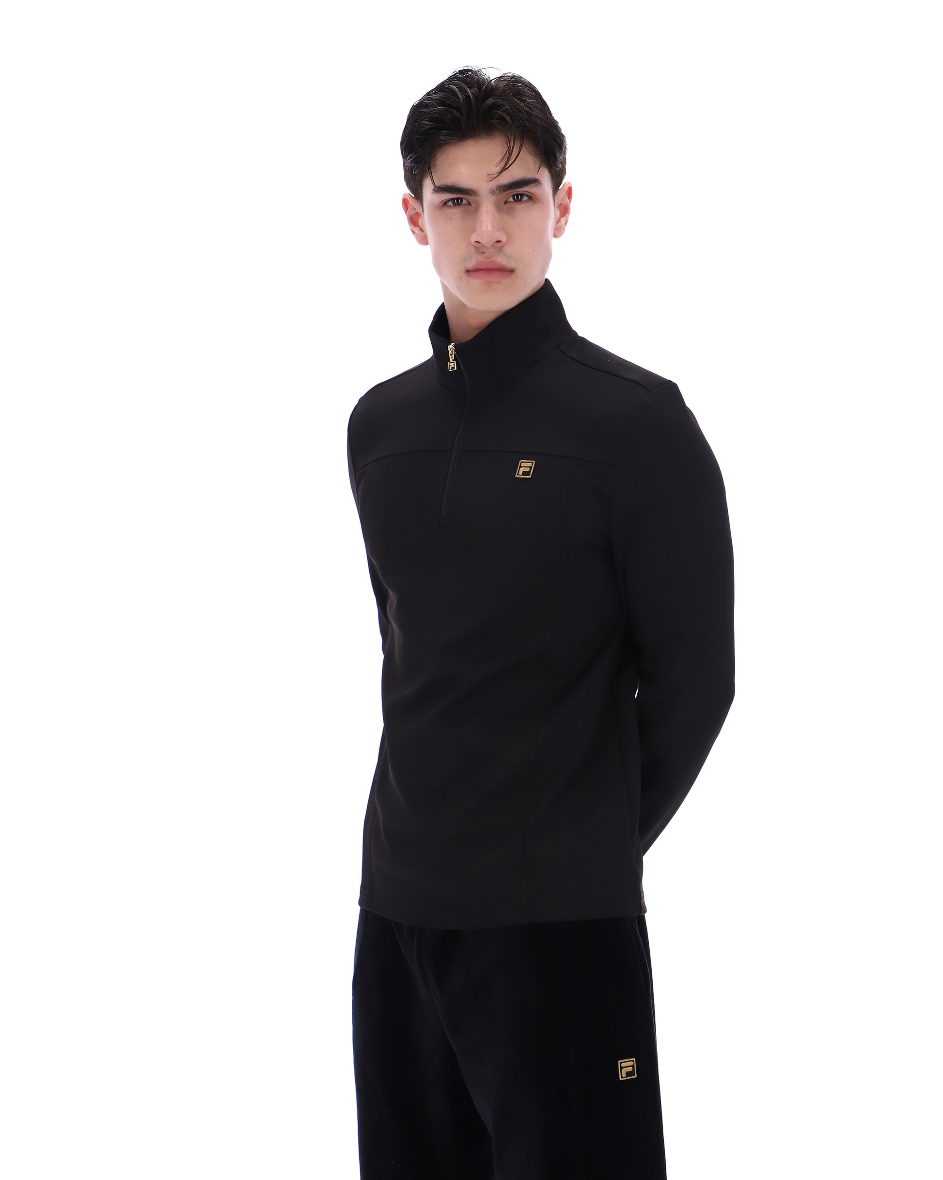 Black Fila Hogan quarter zip jumper with a high collar and subtle logo on the chest, displayed on a neutral background.