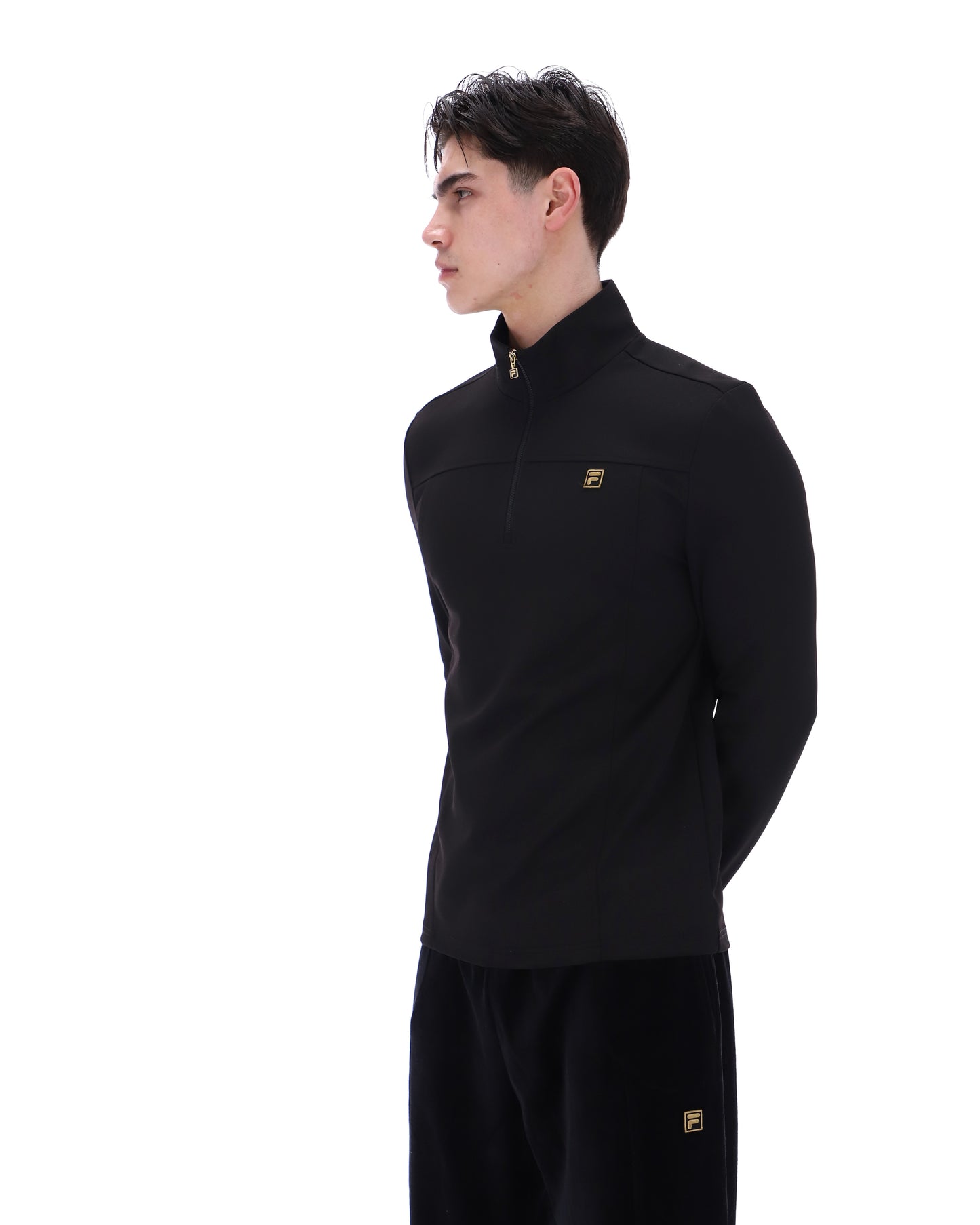 Black Fila Hogan quarter zip jumper with a high collar and subtle logo detail, shown on a hanger.