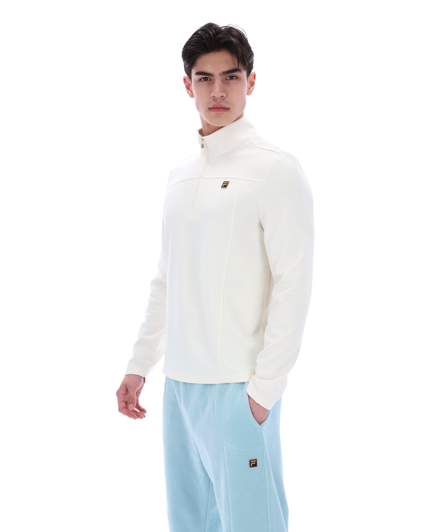 Fila Gold Hogan quarter zip jumper in coconut milk color, featuring a high collar and ribbed cuffs, displayed on a plain background.