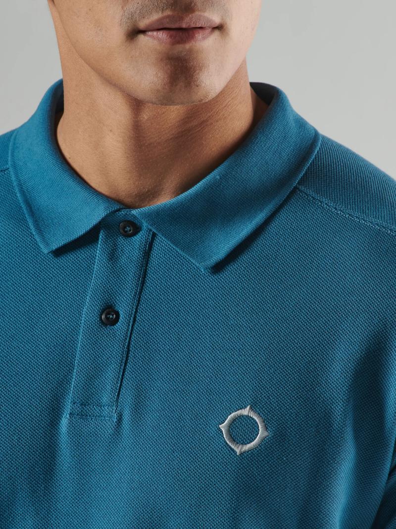 MA.Strum Pique Polo Midnight shirt displayed on a hanger, showcasing the classic navy blue polo with a collared neckline and short sleeves.