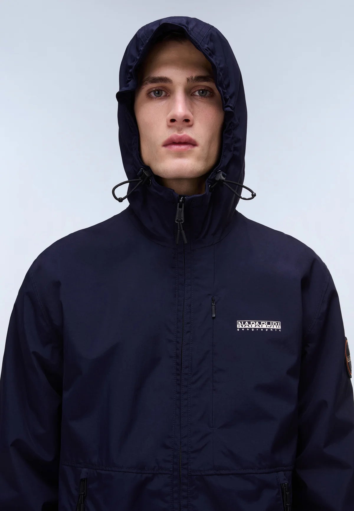 Navy Napapijri Tundra Jacket with hood and zipper, featuring quilted design and logo patch on the sleeve.