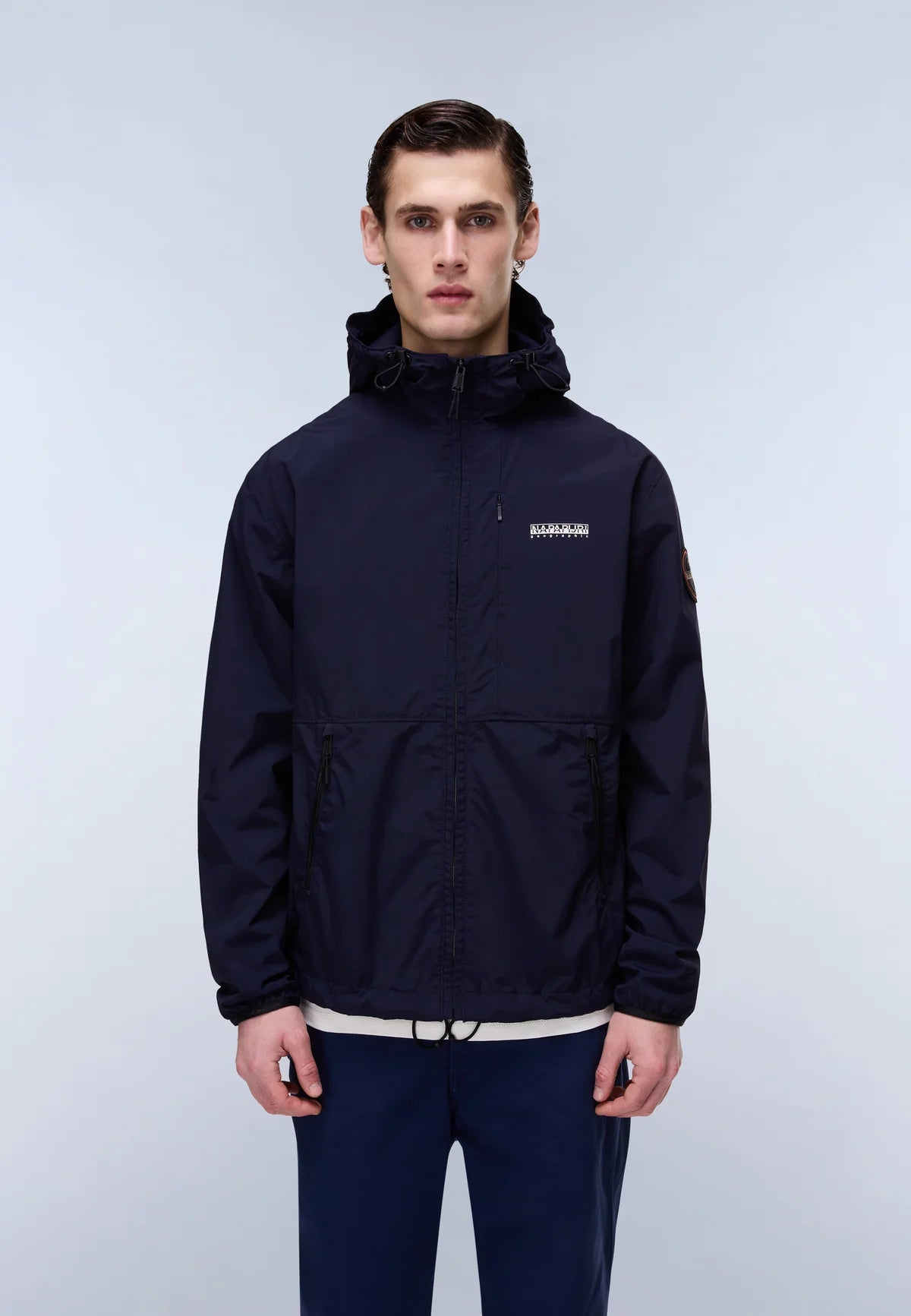 Navy Napapijri Tundra jacket with hood and zip closure, displayed on a hanger against a plain background.