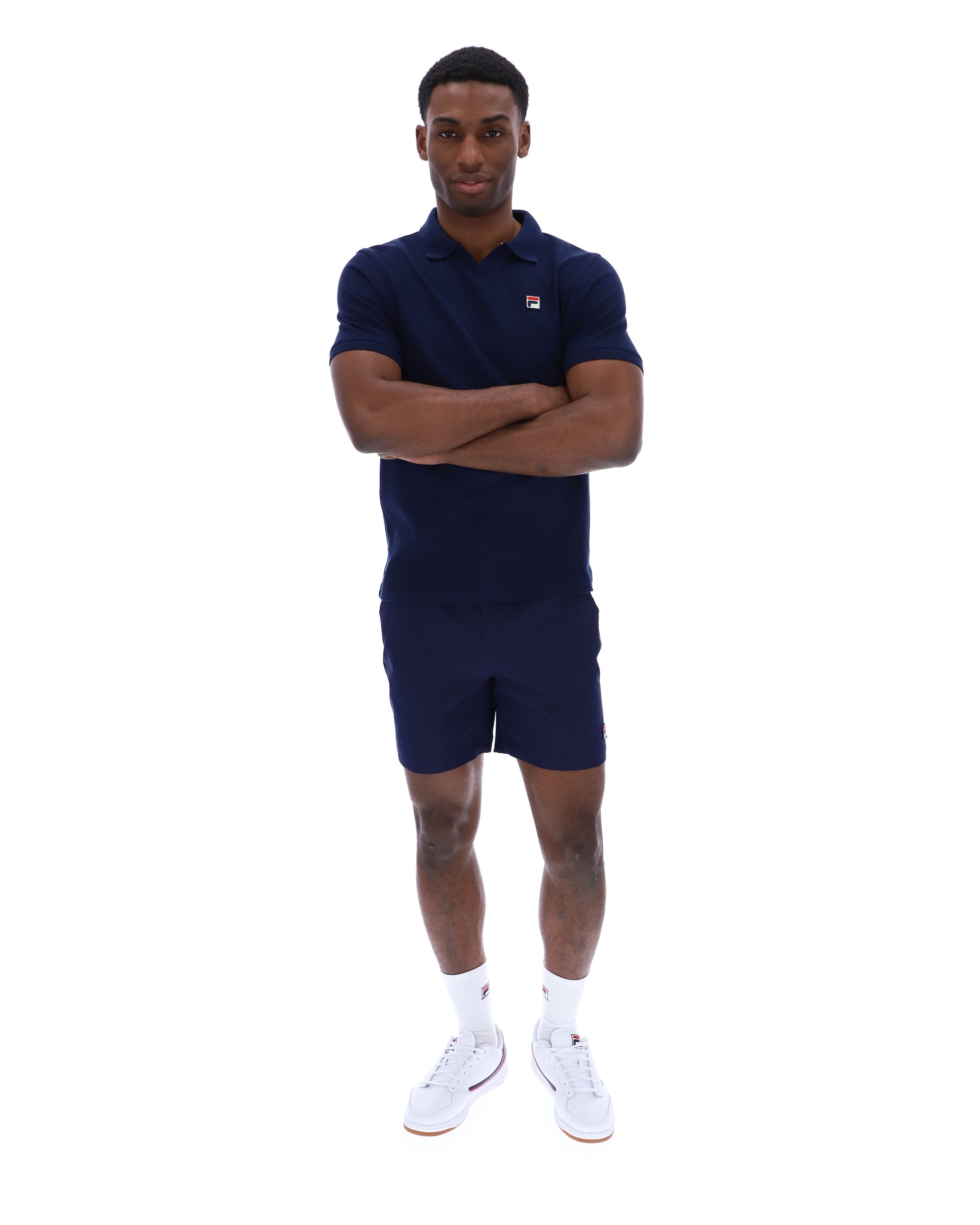 Fila Tristiano navy polo shirt with classic collar and short sleeves, displayed on a plain background.