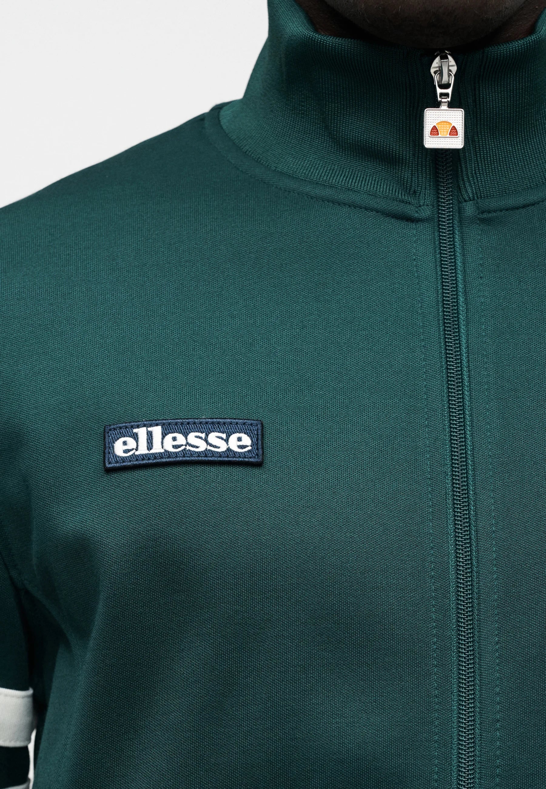 Dark green Ellesse Roma Track Top displayed on a hanger, showcasing its sporty design and lightweight fabric.