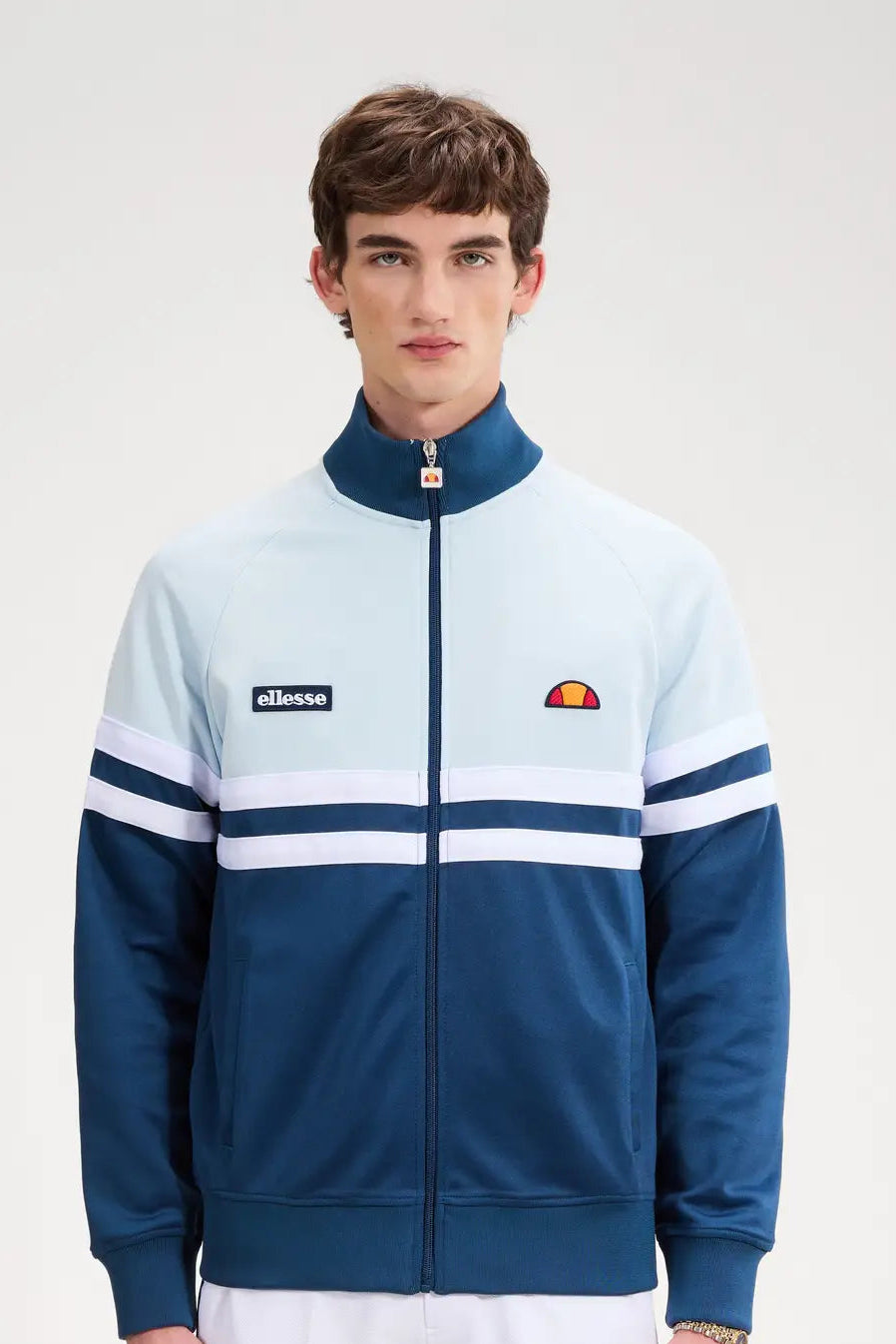 Ellesse Rimini track top in blue and light blue, featuring a sporty design and logo, displayed on a mannequin.