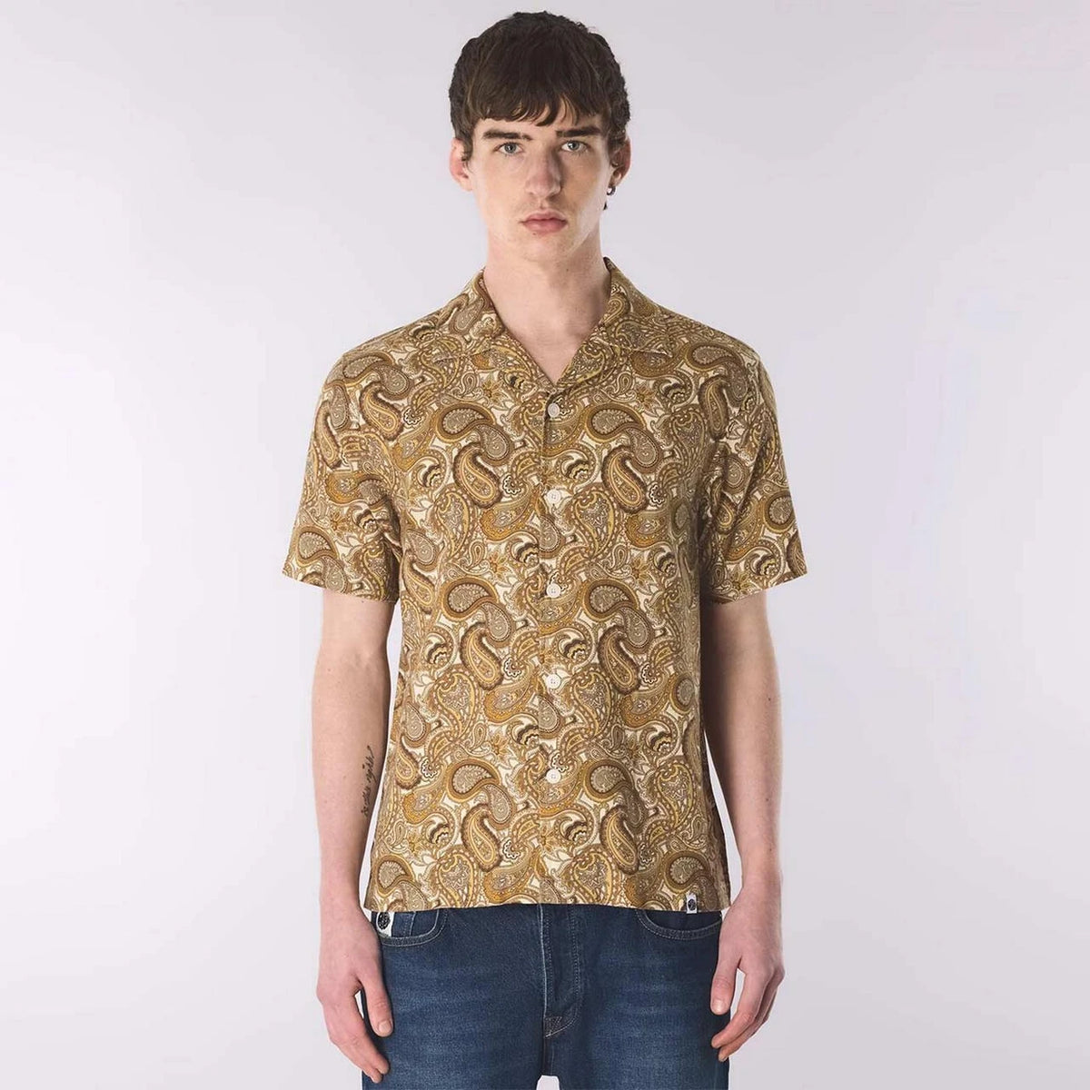 Pretty Green Hermosa Paisley Shirt in gold, featuring retro 70s paisley pattern, long sleeves, and classic collar on a model.