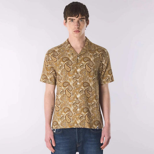Pretty Green Hermosa Paisley Shirt in gold, featuring retro 70s paisley pattern, long sleeves, and classic collar on a model.